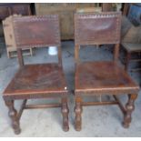 Pair of leather seated chairs with brass studs on turned legs