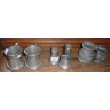 Two commemorative pewter mugs by Spelman of Altrincham, pewter condiment set and two measures