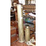 Long brass shell case, another and two brass stanchions