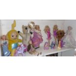 Three Barbie-type dolls, a Teletubby Laa-Laa doll and others, with a small Victorian bisque-headed