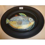 Large oval platter overpainted with black oil paint, and a thickly painted and textured fish.