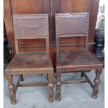 Pair of leather seated chairs with brass studs on turned legs