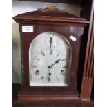 Edwardian mahogany table clock, silver dial, German movement striking on gongs, 18" tall