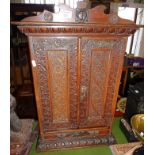 Victorian carved oak two door cabinet having brass embellishments with drawer below, 26" high x