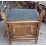 Piano stool with upholstered seat above pull down music compartment