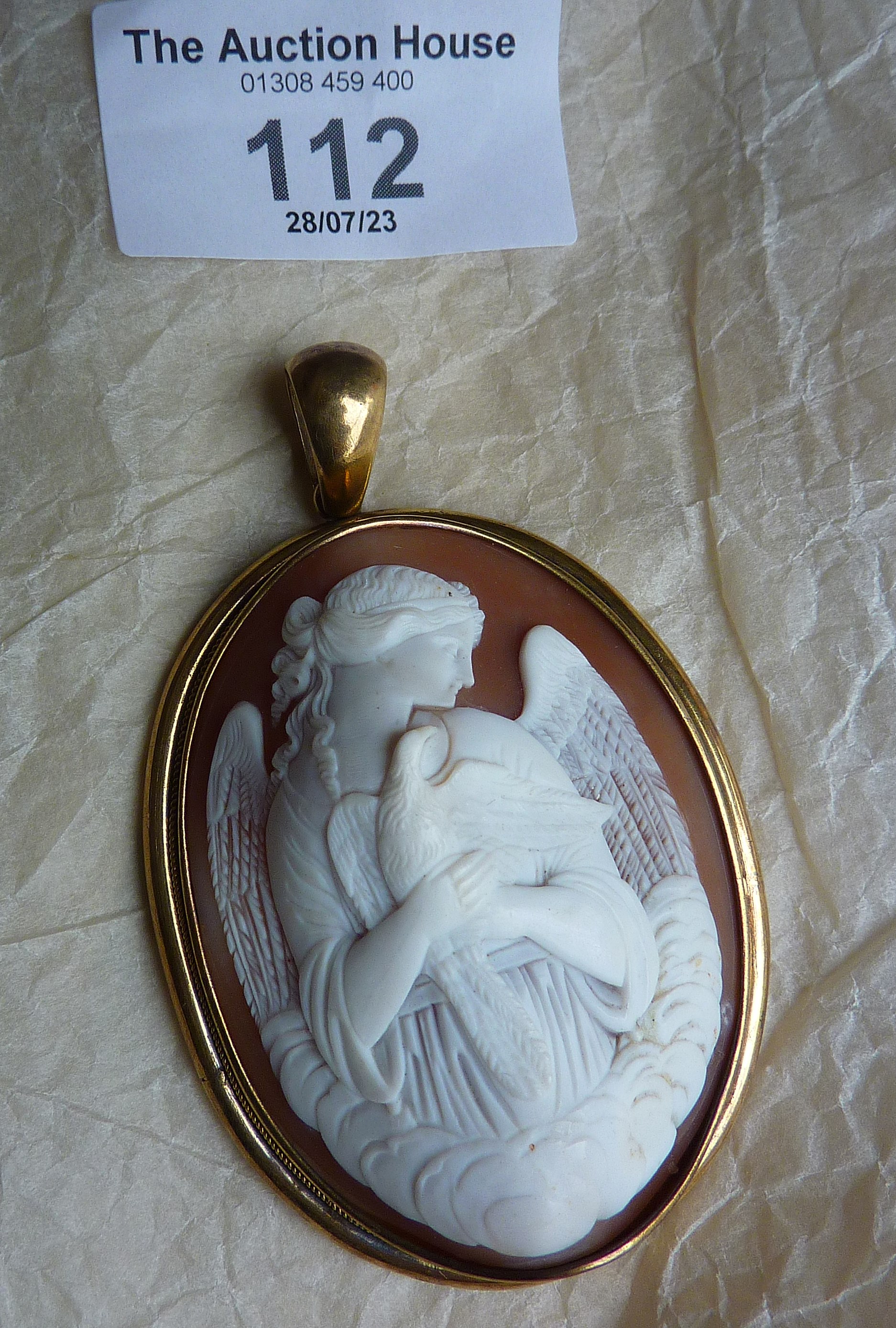 Antique large shell cameo pendant with finely carved angel holding a dove, in gold frame. Approx