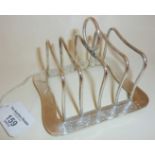 Liberty & Co. silver toast rack with wave-like decorative engraved panels. Hallmarked for Birmingha