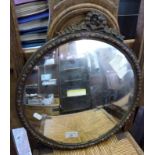 Convex wall mirror in gilt gesso frame