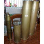Two large brass shell cases (4.5's) and two others smaller