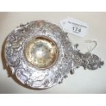 Fancy Edwardian silver tea strainer decorated with repoussé cherubs in the Rococo style.