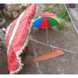 Old garden or beach parasol and a clip-on umbrella