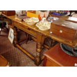 Craftsman built oak drawleaf table on bold turned legs with stretchers and carved freize, 41" long
