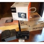 Boxed digital cameras, Canon Powershot A40, Pentax Optio LS1000 and Sony Cybershot DSC W800