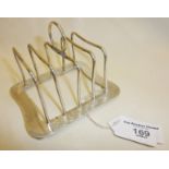 Liberty & Co. silver toast rack with wave-like decorative engraved panels. Hallmarked for Birmingham