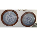 Pair of circular blue and white porcelain panels mounted on silk, 11" diameter inc. frame