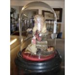 Small folk art doll under glass dome