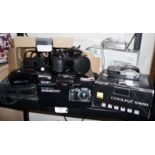A Nikon D70's camera, a Nikon Coolpix, a Minolta Dilmage G600 and an Olympus AF1 Twin camera (