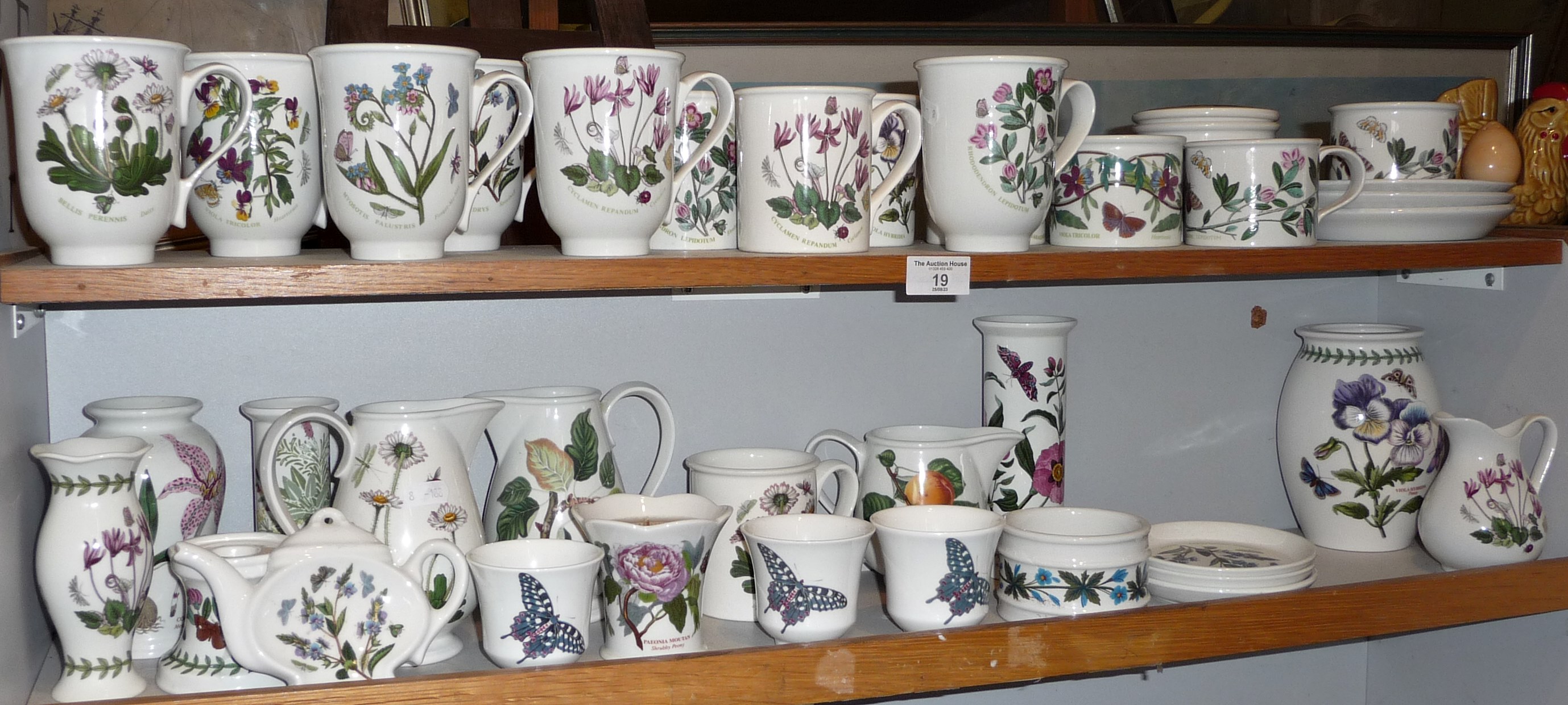 Collection of Portmeirion pottery mugs, cups and jugs, etc. (2 shelves)