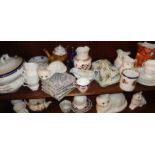 Two shelves of assorted chinaware, inc. tiles and cat figures