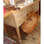 Edwardian limed beechwood kneehole writing desk having five drawers on square tapering legs,