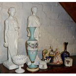 Two plaster statues, continental porcelain chess playing group, a painted glass vase, a crested