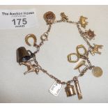 Vintage 9ct gold bracelet hung with many charms all marked as 9ct, apart from a silver mug.