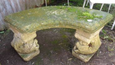 Stonework garden seat on dolphin supports