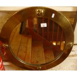 Liberty's Arts & Crafts beaten brass framed circular mirror with four relief reverse ying-yang