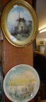 Watercolour in oval frame of a windmill signed Lefebre and a studio pottery painted plate,