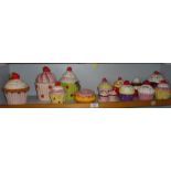 11 novelty china cup cake money boxes, a similar cruet set and a doughnut