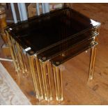 Nest of three brass and smoked glass tables