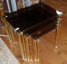 Nest of three brass and smoked glass tables