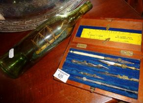 Draughtsman's set in wooden case, with a ship in an old green glass bottle
