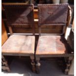 Pair of oak chairs with leather seats and backs