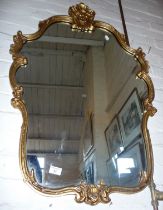 Gilt framed wall mirror with rococo shaped frame