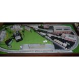 An 'N' gauge train layout with engine sheds, station and houses with a Graham Farish GWR