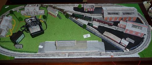 An 'N' gauge train layout with engine sheds, station and houses with a Graham Farish GWR