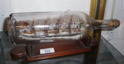 A WW2 prisoner of war ship (S.S. Miriam) in a bottle with diorama backdrop of a town