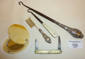 Button hooks, one with silver handle, small silver-handled brush, fruit knife and a celluloid pocket
