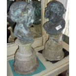 Pair of weathered bronze cherub busts depicting night and day, on later reconstituted stone