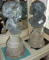 Pair of weathered bronze cherub busts depicting night and day, on later reconstituted stone