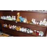 Large collection of novelty china salt and pepper pots (2 shelves)