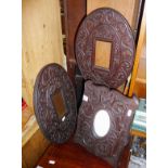 Three carved Arts & Crafts style oak frames, one on easel stand