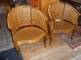 Pair of walnut bergere armchairs in the French style, good canework with cushion seats
