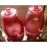 Pair of Cranberry glass 'beehive' barrels with lids and taps