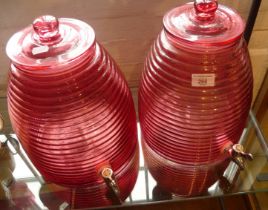 Pair of Cranberry glass 'beehive' barrels with lids and taps