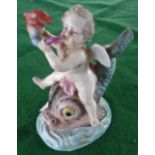 19th c. German porcelain figure of a putti riding a dolphin (A/F), blue painted "R" mark to base