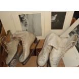 Two pairs of vintage ladies' ice skating boots with a quantity of black and white photographs