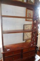 Mahogany four-tier wall shelf with pierced ends and four small drawers