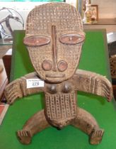 Tribal Art: African carved wood fertility figure of a seated woman with outstretched arms